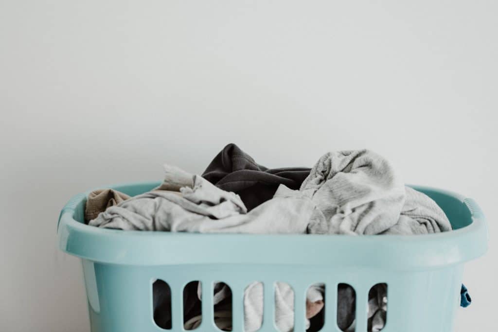 Pile of clothes in a blue laundry basket