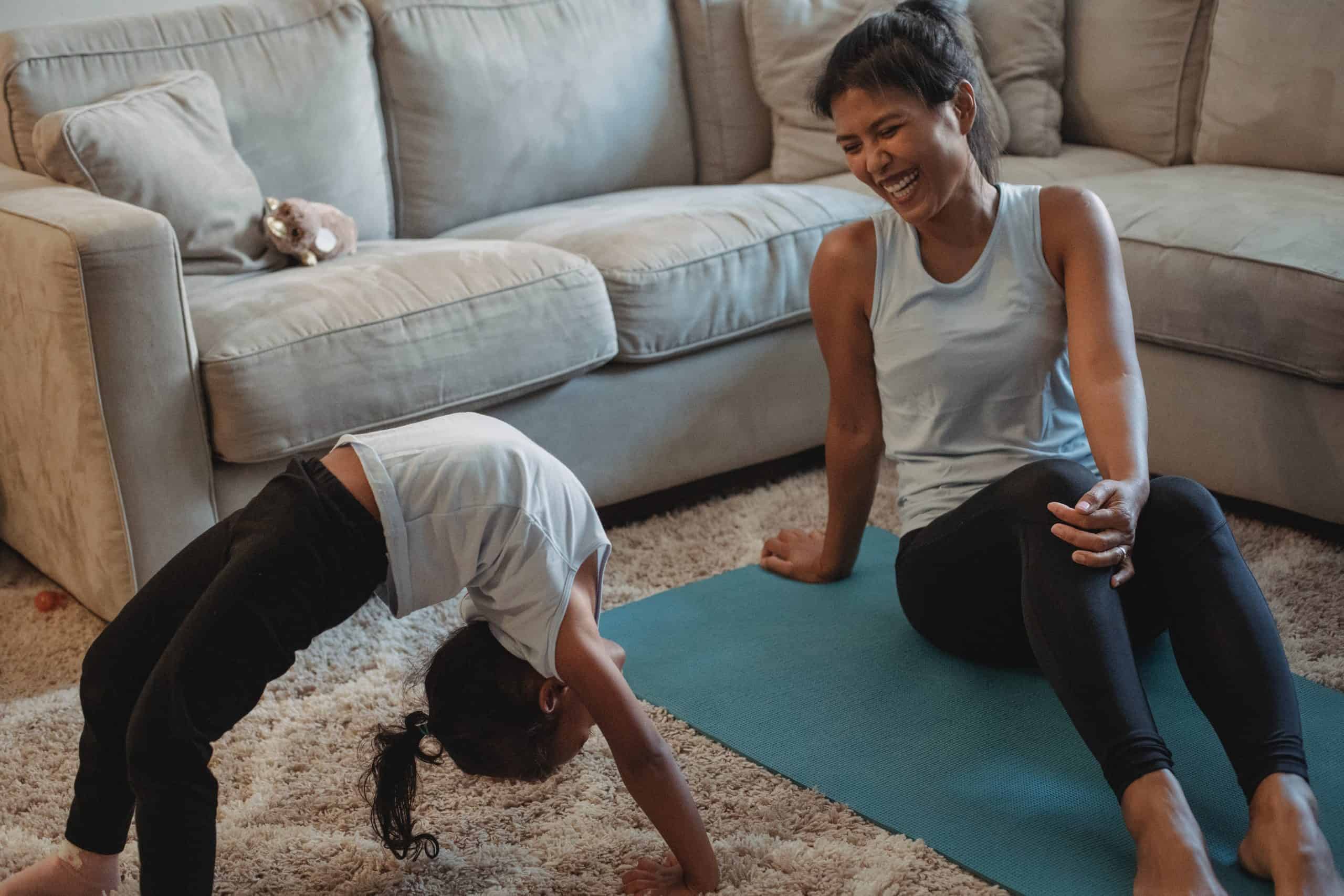 Mom watching her daughter try a backbend