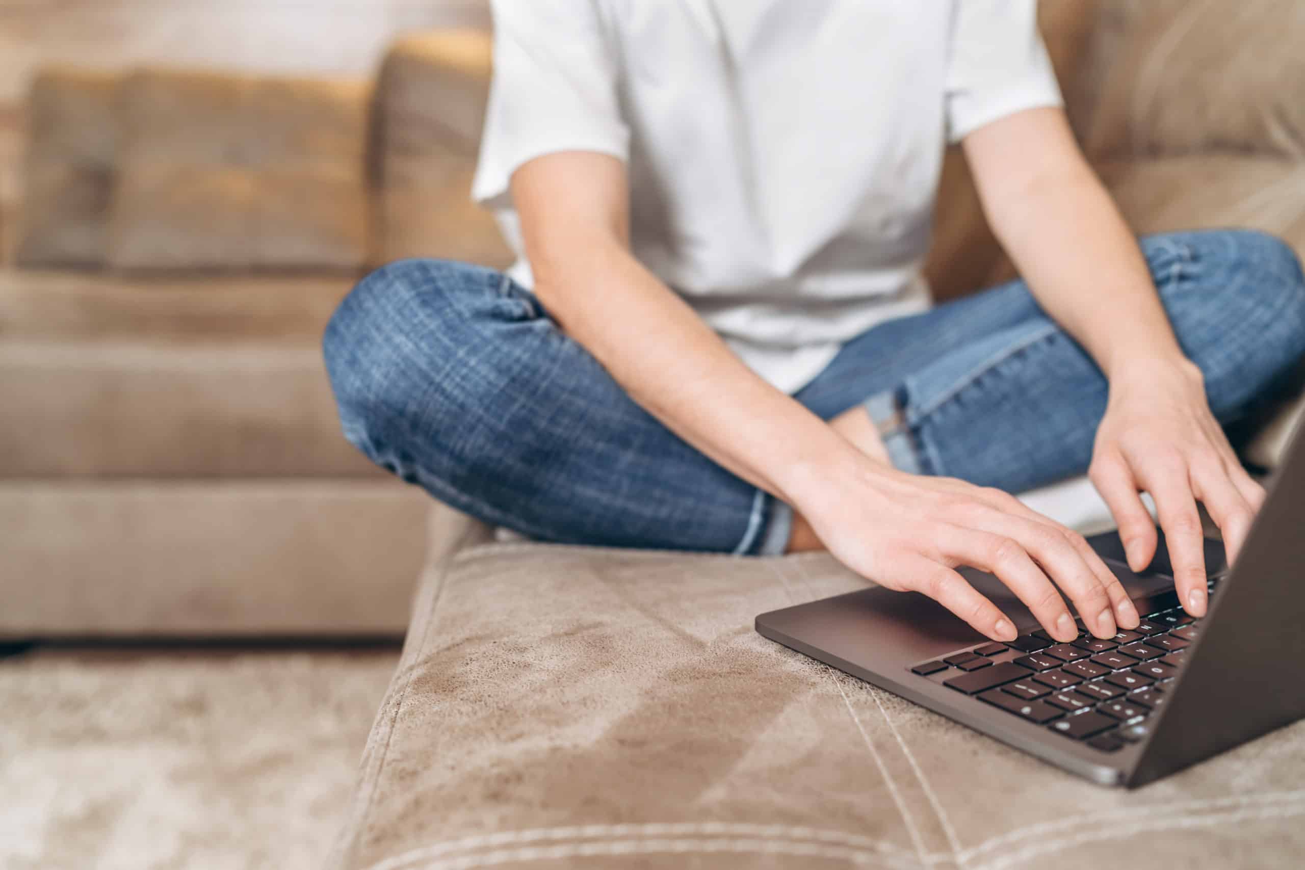 Woman using her laptop on the couch