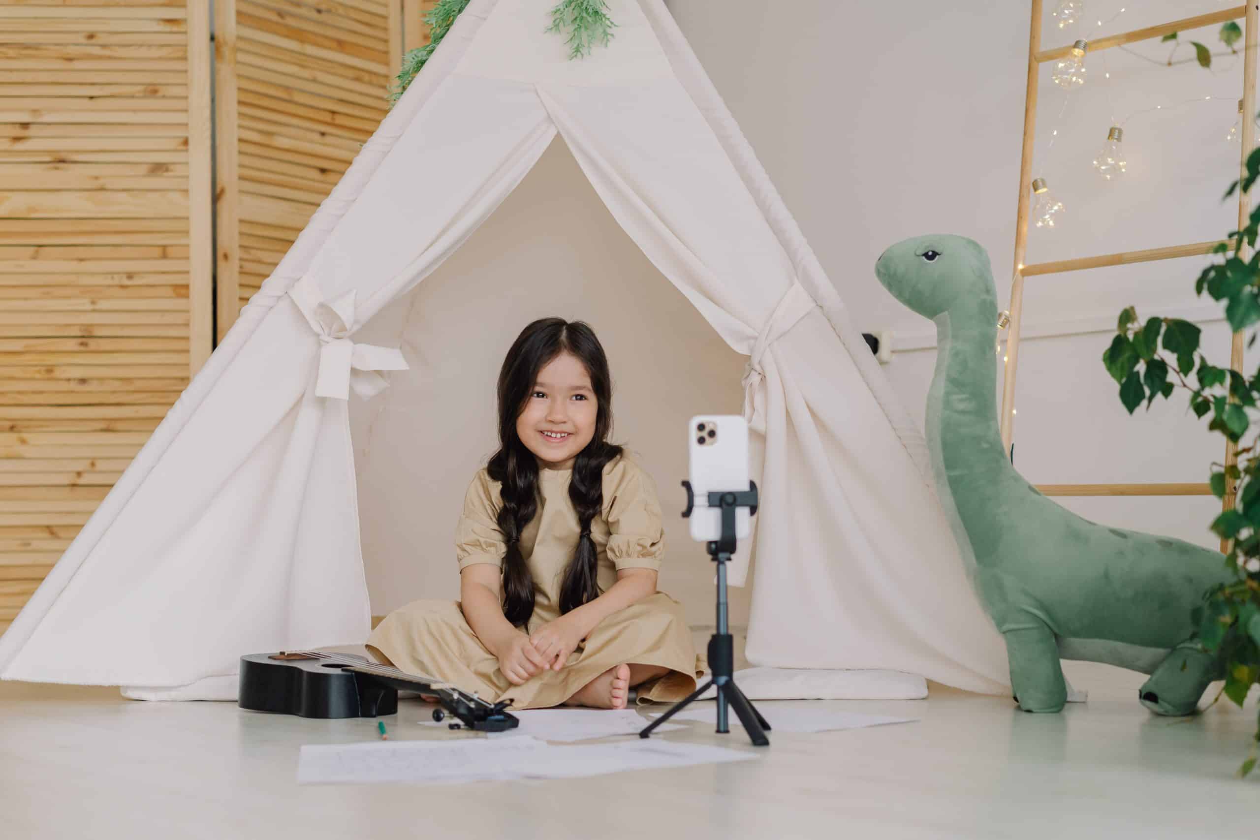 Kid filming a YouTube video in her room